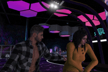 a man and a woman are standing in a room with purple lights