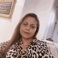 a woman in a leopard print shirt takes a selfie with the date 06/12/2021