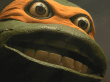 a close up of a teenage mutant ninja turtle 's face with big eyes