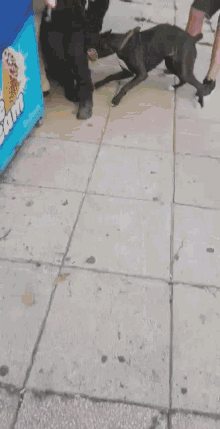 a man standing on a sidewalk next to an ice cream machine that says ' ice cream ' on it