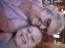 an elderly woman and a young girl are smiling for a picture