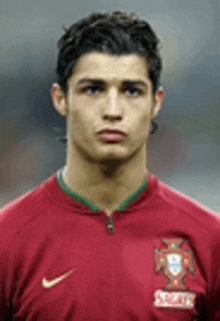 a close up of a soccer player wearing a red nike jersey