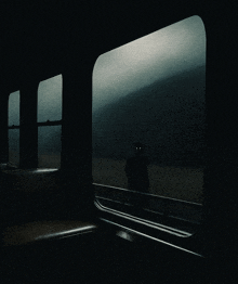 a man with glowing eyes looks out of a window on a train