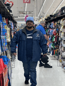 a man wearing a texans jacket stands in a store aisle