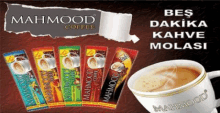 a cup of mahmood coffee next to a bunch of packets