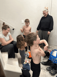 a group of people are gathered in a room and one of them is wearing a crocs shoe