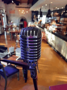 a microphone in a restaurant with a purple light behind it