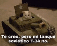 a cat is sitting in a cardboard tank with a flag on top .