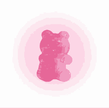 a pink gummy bear on a pink background .