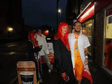 a group of people in costumes are standing in front of a fast food restaurant .