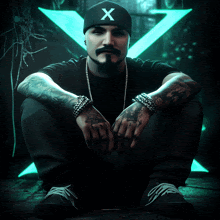 a man wearing a beanie with the letter x on it sits on the ground