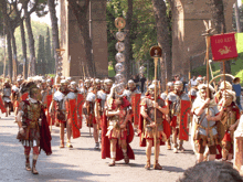 a group of roman soldiers marching down a street with a red banner that says leg xxii