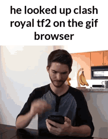 a man looks up clash royal tf2 on the gif browser on his phone