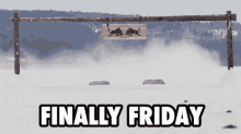 a sign that says " finally friday " hangs over a snowy field