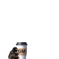 a gm coffee cup is being held by a hand