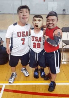 three men are posing for a picture with one wearing a usa jersey