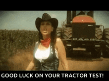 a woman in a cowboy hat is standing in front of a tractor with the words good luck on your tractor test