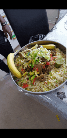 a person holding a bowl of food with a banana on it