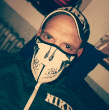 a man wearing a skull mask and a nike jacket