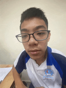 a young man wearing glasses and a shirt that says " mind power " on it