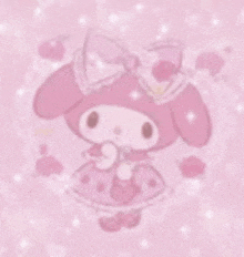 a pink cartoon character with a bow on her head is sitting on a pink surface .