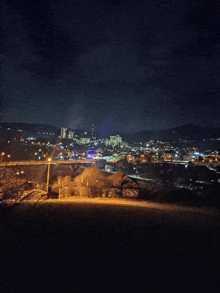 a view of a city at night from a hillside