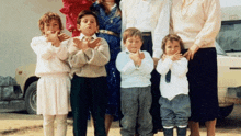 a group of people posing for a picture with their hands in the air