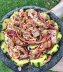 a person is holding a bowl of food with shrimp and avocado .