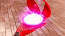 a person in a red glove is holding a glowing object in their hand