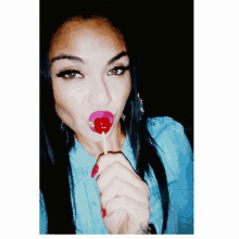 a woman with a lollipop in her mouth