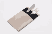 a knife and fork are in a napkin holder