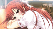 a girl with red hair is laying on a table with her head on her arm