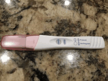 a pregnancy test is sitting on top of a counter .