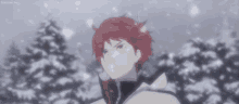 a man with red hair is standing in the snow in front of a snowy forest .