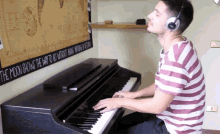 a man playing a piano in front of a sign that says " the moon showing the way to go without going back "