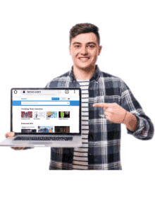 a man in a plaid shirt is holding a laptop and pointing at the screen which says tenor.com