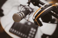 a close up of a microphone and headphones on a desk