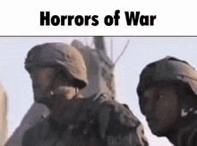 two soldiers are standing next to each other in front of a building with the words `` horrors of war '' written above them .