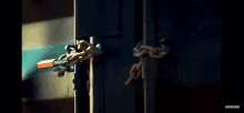 a close up of a door with chains and a key on it .