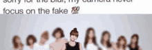 a woman stands in front of a group of women with the words focus on the fake 100 below her