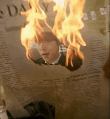 a man in a suit is burning on a newspaper .