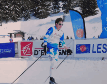 a man is skiing in front of a sign that says " les "