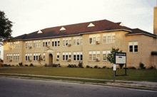 a large brick building with a sign in front of it that says sc carolina schools