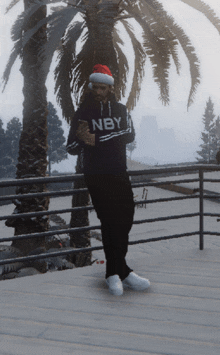 a man wearing a santa hat and a hoodie that says nby on it