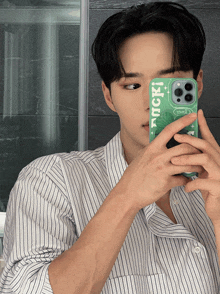 a man taking a picture of himself with a phone case that says luck