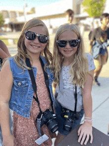 two young girls wearing sunglasses that say dance party on them