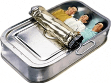 three men are laying in a tin can with the lid open