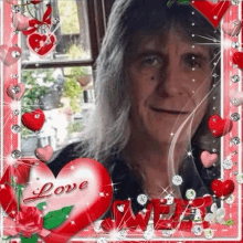 a man with long hair is surrounded by red hearts and flowers .