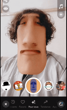 a man 's face is being altered in a photo app with the number 613 m on the bottom