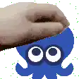 a pixel art of a hand touching a blue octopus with white eyes .